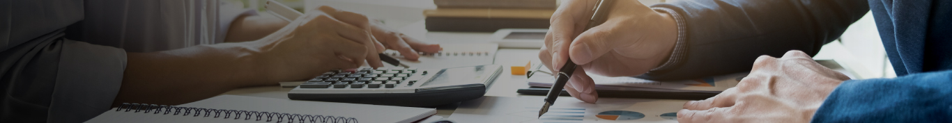 Two people working with charts in an office